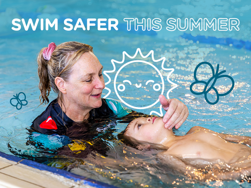 Swim teacher supporting child swimming